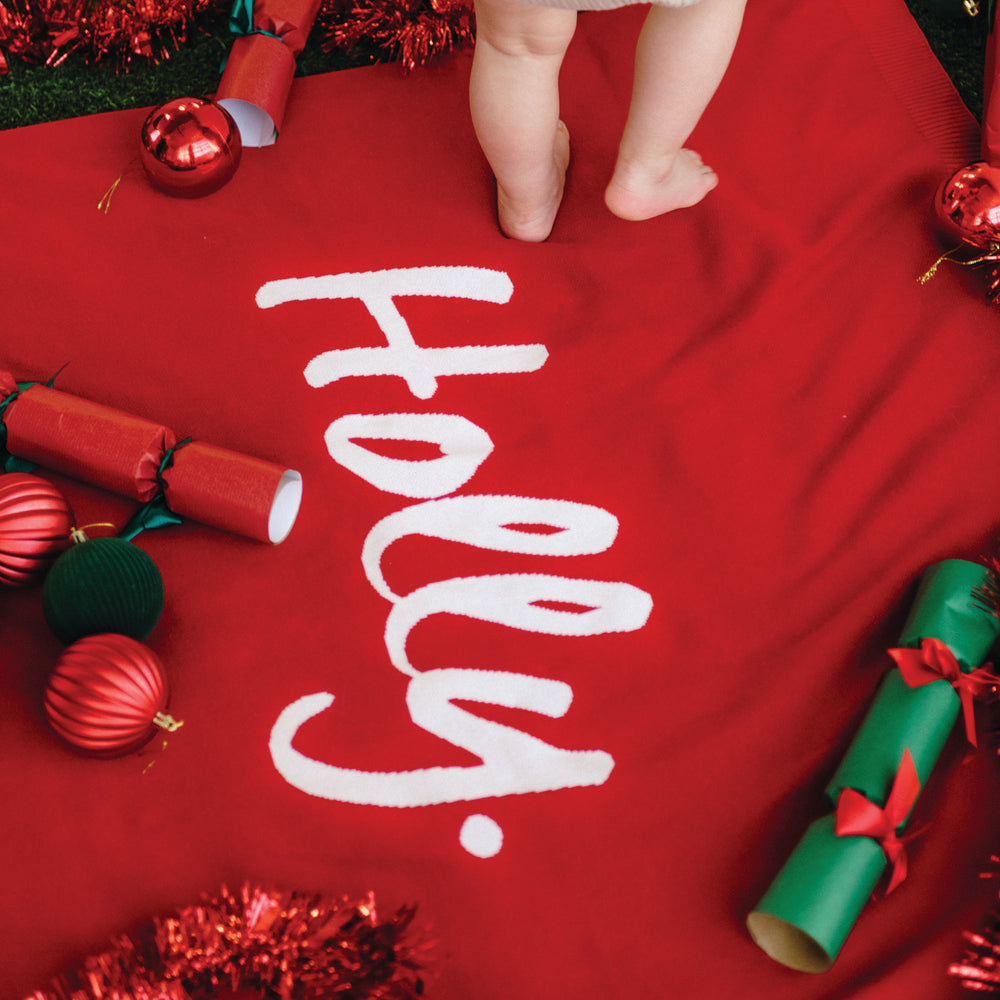 
                  
                    Load image into Gallery viewer, Red Christmas blanket with the name &amp;#39;Holly&amp;#39; knitted in white.
                  
                